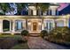Inviting front porch with seating and a stone pathway leading to a beautiful wood front door at 2429 Kirk Nw Ln, Kennesaw, GA 30152