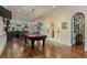 Open game room with a pool table and hardwood floors transitions to a bar area at 2429 Kirk Nw Ln, Kennesaw, GA 30152