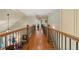 Upper hallway showcasing hardwood floors, dark iron railings and open floor plan views at 2429 Kirk Nw Ln, Kennesaw, GA 30152