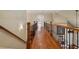 Elegant upper hallway with beautiful wood floors and wrought iron railings leads to other rooms at 2429 Kirk Nw Ln, Kennesaw, GA 30152