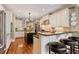 Open kitchen with white cabinets, stainless appliances, granite counters and a breakfast bar with seating at 2429 Kirk Nw Ln, Kennesaw, GA 30152