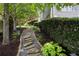 Beautiful landscaping along a stone path with lush greenery and mature trees surrounding the home at 2429 Kirk Nw Ln, Kennesaw, GA 30152