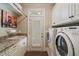Functional laundry room equipped with a sink, granite countertops, washer, and dryer at 2429 Kirk Nw Ln, Kennesaw, GA 30152