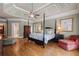 Spacious main bedroom featuring a four-poster bed, hardwood floors, and elegant tray ceiling design at 2429 Kirk Nw Ln, Kennesaw, GA 30152
