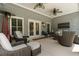 Relaxing covered patio with comfortable seating and ceiling fans at 2429 Kirk Nw Ln, Kennesaw, GA 30152