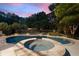 Backyard pool featuring a connecting circular hot tub area, surrounded by lush landscaping and privacy fencing at 2429 Kirk Nw Ln, Kennesaw, GA 30152