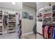 Organized walk-in closet with custom shelving, hanging rods, and ample storage space for clothes and shoes at 2429 Kirk Nw Ln, Kennesaw, GA 30152