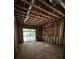Unfinished living room space showing framing, insulation, and sliding glass doors to the backyard at 308 Fortune Ne St # A, Atlanta, GA 30312