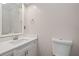 Clean bathroom featuring a sink with quartz countertop, mirror, and toilet at 6 Alston Place Ne Ne Pl, Atlanta, GA 30324