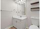 Bathroom with single sink vanity, mirror, shelving, and toilet at 6 Alston Place Ne Ne Pl, Atlanta, GA 30324