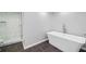 Modern bathroom featuring a freestanding tub and a frameless glass shower with marble-look tile at 6 Alston Place Ne Ne Pl, Atlanta, GA 30324