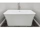 Close up of the bright white free standing soaking tub with modern hardware at 6 Alston Place Ne Ne Pl, Atlanta, GA 30324