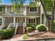Inviting townhome exterior featuring a well-maintained facade, brick steps and mature landscaping at 6 Alston Place Ne Ne Pl, Atlanta, GA 30324