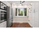 Charming breakfast nook in the kitchen with white cabinets, stainless steel appliances, and large window at 6 Alston Place Ne Ne Pl, Atlanta, GA 30324