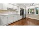 Bright modern kitchen with stainless appliances, a large window, and hardwood floors at 6 Alston Place Ne Ne Pl, Atlanta, GA 30324