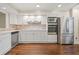 Modern kitchen featuring white cabinets, stainless steel appliances, and stone backsplash at 6 Alston Place Ne Ne Pl, Atlanta, GA 30324