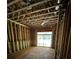Unfinished bonus room during construction showcasing wood framing, window and sliding doors with natural light at 308 Fortune Ne St # B, Atlanta, GA 30312