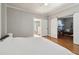 Spacious primary bedroom with hardwood floors features a sliding barn door and en-suite bathroom at 761 Bellemeade Nw Ave, Atlanta, GA 30318