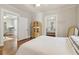Bedroom features a twin bed, hardwood floors, and view into the kitchen and second bedroom at 761 Bellemeade Nw Ave, Atlanta, GA 30318