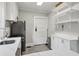 Modern kitchen with white cabinets, stainless steel appliances, and ample countertop space at 761 Bellemeade Nw Ave, Atlanta, GA 30318