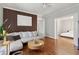 Inviting living room with hardwood floors, a modern accent wall, and an open layout at 761 Bellemeade Nw Ave, Atlanta, GA 30318