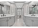 Bright bathroom showcasing dual vanities, large mirrors, and views into the main bedroom at 2559 Dunhaven Gln, Snellville, GA 30078