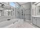Modern bathroom featuring a marble-trimmed soaking tub and glass-enclosed shower with gray walls at 2559 Dunhaven Gln, Snellville, GA 30078