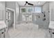 A spacious bathroom features a shower, soaking tub, double sink, and large windows at 2559 Dunhaven Gln, Snellville, GA 30078