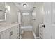 Neutral-toned bathroom features marble-look tiled shower, built-in cabinets, and a single sink at 2559 Dunhaven Gln, Snellville, GA 30078