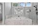 Beautiful bathroom featuring marble hexagon tiling, a soaking tub, and a glass enclosed shower at 2559 Dunhaven Gln, Snellville, GA 30078