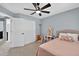 Comfortable bedroom with light blue walls, a ceiling fan, and a closet at 2559 Dunhaven Gln, Snellville, GA 30078