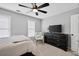 Comfortable bedroom with ceiling fan, two windows, and space for a dresser and TV at 2559 Dunhaven Gln, Snellville, GA 30078