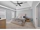 Bright bedroom with tray ceiling, ceiling fan, large window, and carpeted floors at 2559 Dunhaven Gln, Snellville, GA 30078