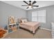 Cozy bedroom with a neutral color scheme, a ceiling fan, and large window for ample light at 2559 Dunhaven Gln, Snellville, GA 30078