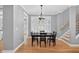 Dining room with a table for four, hardwood floors, and a view of the staircase at 2559 Dunhaven Gln, Snellville, GA 30078