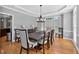 Elegant dining room featuring a stylish chandelier, wood floors, and large windows at 2559 Dunhaven Gln, Snellville, GA 30078