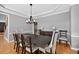 Bright dining room showcases a modern chandelier and a large wood dining table at 2559 Dunhaven Gln, Snellville, GA 30078