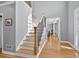 Bright entryway with hardwood floors, staircase with wooden and black iron railings, and high ceilings at 2559 Dunhaven Gln, Snellville, GA 30078