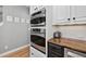 Kitchen with stainless steel oven, and microwave, white cabinets, granite counter tops and tile backsplash at 2559 Dunhaven Gln, Snellville, GA 30078