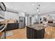 Modern kitchen with stainless steel appliances, granite counters, hardwood floors, and views to living area at 2559 Dunhaven Gln, Snellville, GA 30078