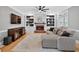 Cozy living room with fireplace, TV console, and plush sectional sofa at 2559 Dunhaven Gln, Snellville, GA 30078