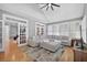 Sunlit living room featuring hardwood floors, vaulted ceiling, and comfortable sectional sofa at 2559 Dunhaven Gln, Snellville, GA 30078