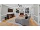 Beautiful living room with fireplace, built-in shelves, hardwood floors, and a comfortable gray sofa at 2559 Dunhaven Gln, Snellville, GA 30078
