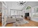 Bright living room with vaulted ceiling, shutters, french doors, TV console, and sectional sofa at 2559 Dunhaven Gln, Snellville, GA 30078