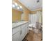Bathroom featuring granite counters, white cabinetry, and a shower-tub combination at 2670 Trotters Pointe Drive Dr, Snellville, GA 30039