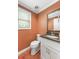 Charming powder room with granite countertops, white vanity, and a framed mirror at 2670 Trotters Pointe Drive Dr, Snellville, GA 30039