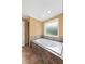 Bathroom features a luxurious built-in bathtub with jets and a frosted glass window for privacy at 2670 Trotters Pointe Drive Dr, Snellville, GA 30039