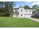 Charming two-story home featuring a covered porch, attached garage, and well-manicured lawn at 2670 Trotters Pointe Drive Dr, Snellville, GA 30039