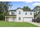 Charming two-story home featuring a covered porch, attached garage, and well-manicured lawn at 2670 Trotters Pointe Drive Dr, Snellville, GA 30039
