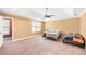 Spacious main bedroom featuring a ceiling fan and two beds on carpeted floors at 2670 Trotters Pointe Drive Dr, Snellville, GA 30039